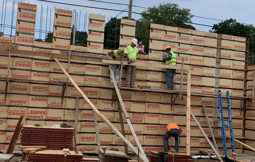 Crew on a scaffold setting tall wall forms