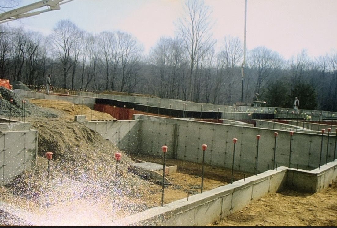 Older photo of finished foundation walls with capped rebar