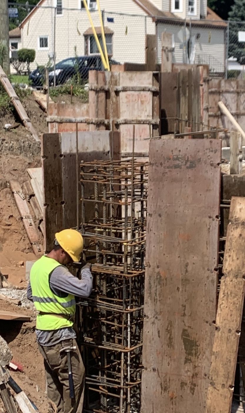 Crew member tying a rebar cage for a column