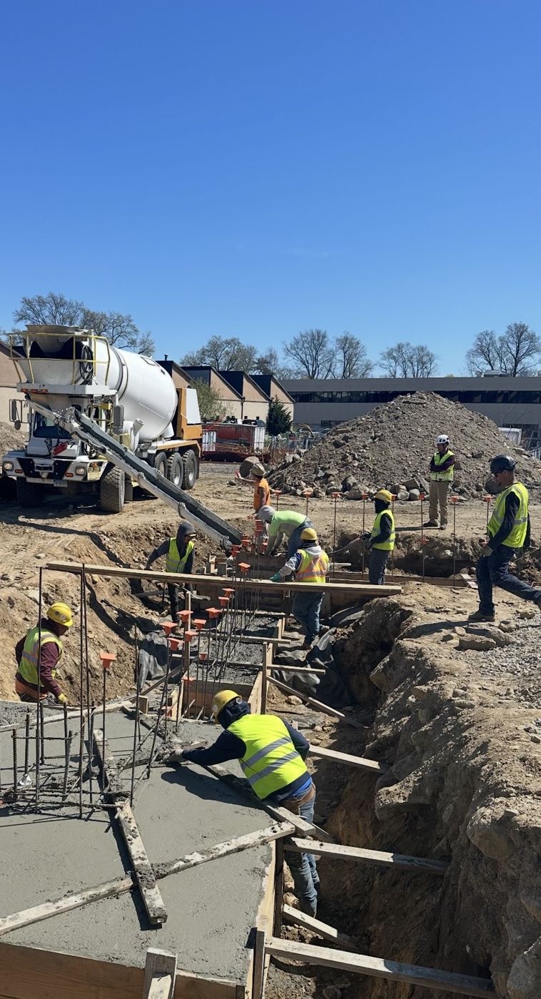 Crew pouring commercial footings from a mixer truck