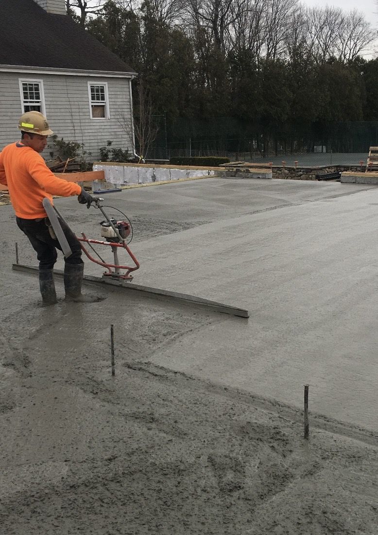 Crew member screeding a fresh slab